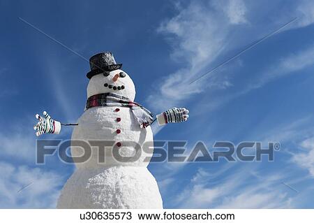 Snowman under blue sky View Large Photo Image Stock Image - Snowman under blue sky. Fotosearch