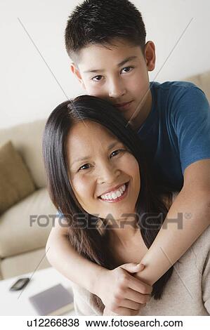Stock Photo - Son embracing mother. Fotosearch