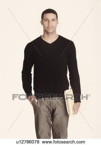 Studio portrait of man holding folders View Large Photo Image Stock Photo - Studio portrait of man holding folders. Fotosearch