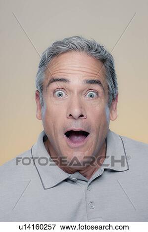 Studio Portrait of mature man looking surprised View Large Photo Image Stock Photo - Studio Portrait of mature man looking surprised. Fotosearch