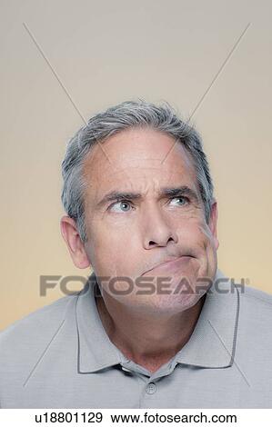 Studio Portrait of mature man making a face View Large Photo Image Stock Photo - Studio Portrait of mature man making a face. Fotosearch