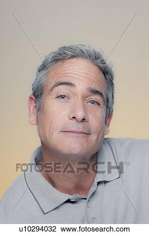 Stock Image - Studio Portrait of mature man smiling. Fotosearch