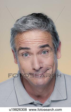 Stock Photo - Studio Portrait of mature man smiling. Fotosearch