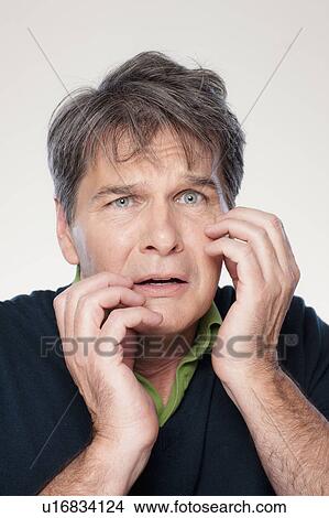 Picture - Studio portrait of mature man with facial expression. Fotosearch