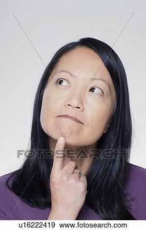 Studio portrait of mature woman looking up View Large Photo Image Stock Photo - Studio portrait of mature woman looking up. Fotosearch