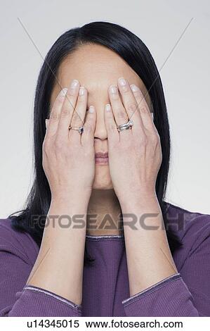 Studio portrait of mature woman covering eyes View Large Photo Image Stock Photography - Studio portrait of mature woman covering eyes. Fotosearch