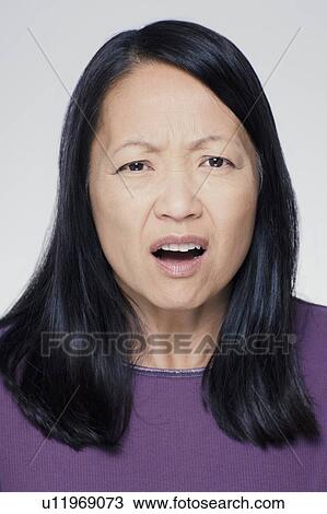 Studio portrait of mature woman with facial expression View Large Photo Image Stock Image - Studio portrait of mature woman with facial expression. Fotosearch