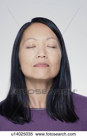 Studio portrait of mature woman with eyes closed View Large Photo Image Stock Photography - Studio portrait of mature woman with eyes closed. Fotosearch