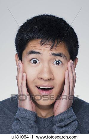 Studio portrait of young man with head in hands View Large Photo Image Stock Image - Studio portrait of young man with head in hands. Fotosearch