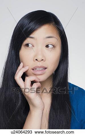 Stock Image - Studio portrait of young woman. Fotosearch
