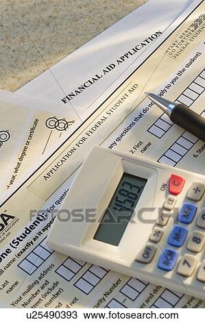 Stock Image - Studio shot of application form and calculator. Fotosearch