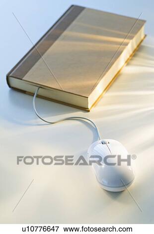 Stock Photo - Studio shot of book with computer mouse. Fotosearch