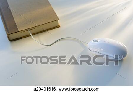 Stock Photograph - Studio shot of book with computer mouse. Fotosearch
