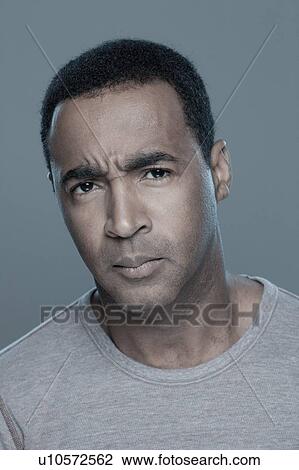Studio shot of confused man View Large Photo Image Stock Image - Studio shot of confused man. Fotosearch