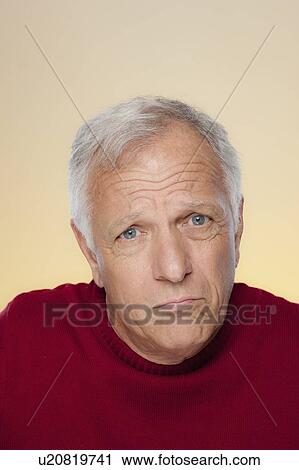Stock Image - Studio shot of confused senior man. Fotosearch