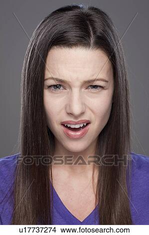 Studio shot of confused woman View Large Photo Image Picture - Studio shot of confused woman. Fotosearch