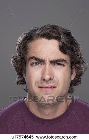 Stock Photography - Studio shot of confused young man. Fotosearch