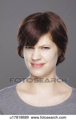 Studio shot of confused young woman View Large Photo Image Stock Photo - Studio shot of confused young woman. Fotosearch