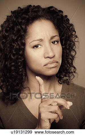 Stock Photo - Studio shot of displeased mid adult woman. Fotosearch
