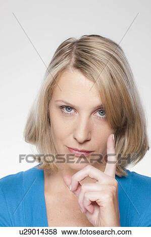 Studio shot of displeased woman gesturing View Large Photo Image Stock Photo - Studio shot of displeased woman gesturing. Fotosearch