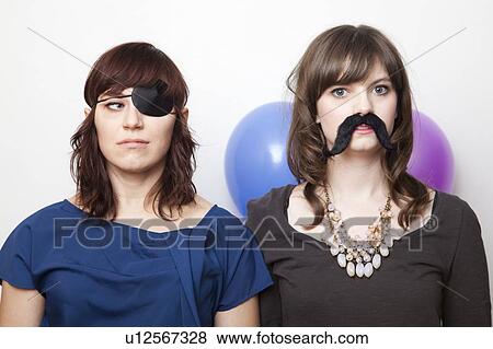 Studio Shot of dressed up young women View Large Photo Image Stock Photo - Studio Shot of dressed up young women . Fotosearch