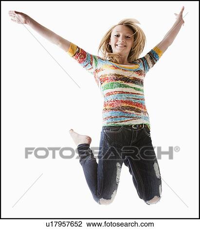 Studio shot of girl (12-13) jumping with arms raised View Large Photo Image Stock Image - Studio shot of girl (12-13) jumping with arms raised. Fotosearch