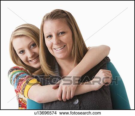 Studio shot of girl (12-13) with mother View Large Photo Image Picture - Studio shot of girl (12-13) with mother. Fotosearch