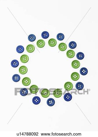 Stock Image - Studio shot of green and blue buttons arranged in circle. Fotosearch