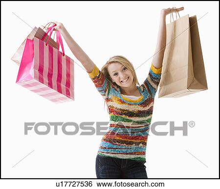 Studio shot of happy girl (12-13) with shopping bags View Large Photo Image Stock Photograph - Studio shot of happy girl (12-13) with shopping bags. Fotosearch