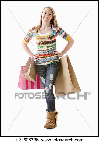 Studio shot of happy girl (12-13) with shopping bags View Large Photo Image Stock Photograph - Studio shot of happy girl (12-13) with shopping bags. Fotosearch
