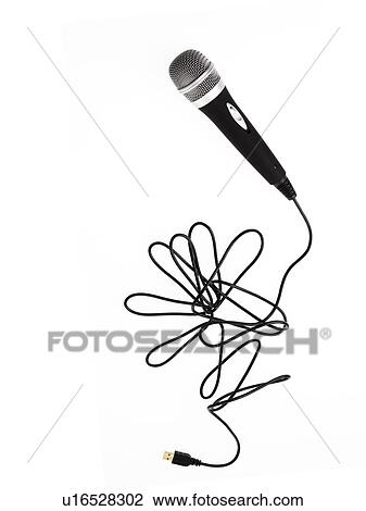 Stock Image - Studio shot of microphone and microphone cable on white background. Fotosearch