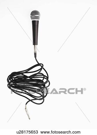 Stock Image - Studio shot of microphone and microphone cable on white background. Fotosearch