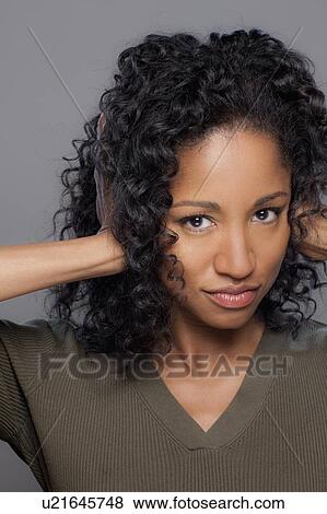 Studio shot of mid adult woman covering ears View Large Photo Image Stock Photo - Studio shot of mid adult woman covering ears. Fotosearch
