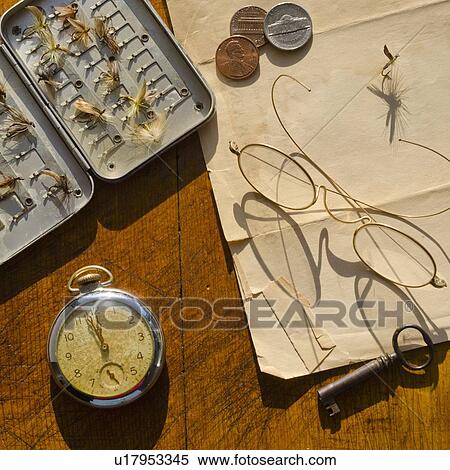 Studio shot of old pocket watch glasses, coins and fake flies View Large Photo Image Stock Photography - Studio shot of old pocket watch glasses, coins and fake flies. Fotosearch