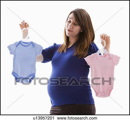 Studio Shot of pregnant woman holing baby onesie View Large Photo Image Stock Image - Studio Shot of pregnant woman holing baby onesie. Fotosearch
