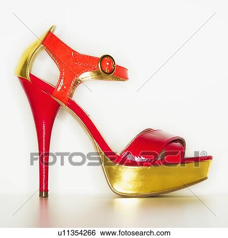 Stock Photograph - Studio shot of red and gold stiletto. Fotosearch