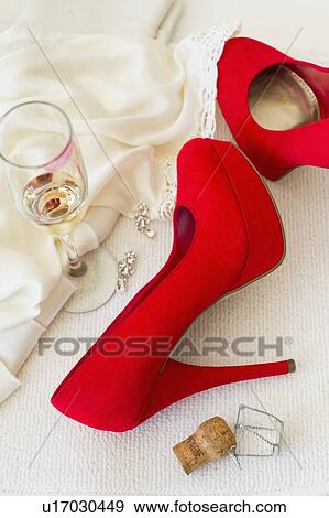 Stock Photo - Studio shot of red stilettos glass of wine and cork. Fotosearch
