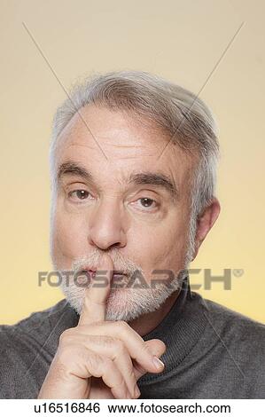 Studio shot of senior man with finger on her lips View Large Photo Image Stock Photograph - Studio shot of senior man with finger on her lips. Fotosearch