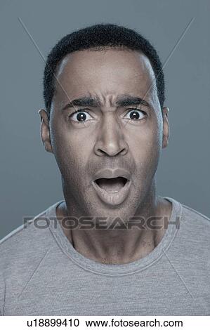 Stock Image - Studio shot of shocked man. Fotosearch