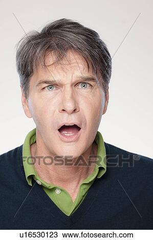 Studio shot of shocked mid adult man View Large Photo Image Stock Image - Studio shot of shocked mid adult man. Fotosearch