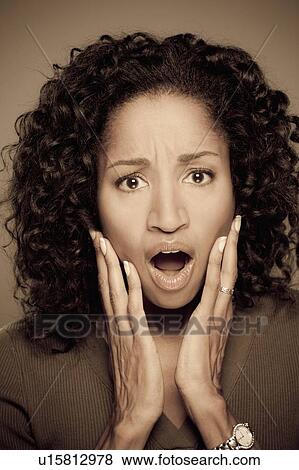 Stock Photo - Studio shot of shocked mid adult woman. Fotosearch
