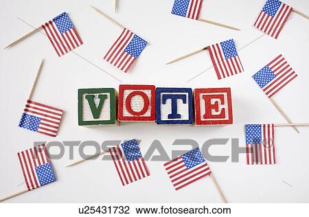 Stock Image - Studio shot of small american flags and wooden blocks with text VOTE . Fotosearch