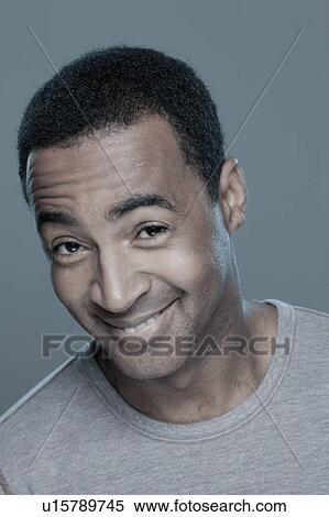 Stock Photography - Studio shot of smiling man. Fotosearch