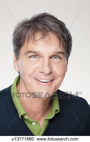 Stock Image - Studio shot of smiling mature man. Fotosearch