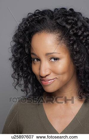 Studio shot of smiling mid adult woman View Large Photo Image Stock Photo - Studio shot of smiling mid adult woman. Fotosearch
