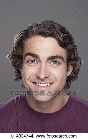 Studio shot of smiling young man View Large Photo Image Picture - Studio shot of smiling young man. Fotosearch