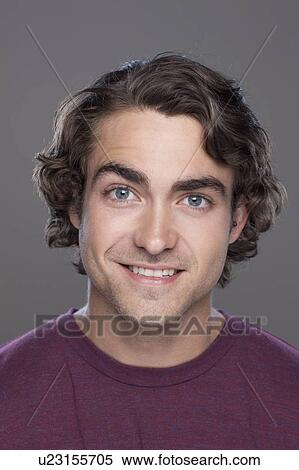 Studio shot of smiling young man View Large Photo Image Stock Photography - Studio shot of smiling young man. Fotosearch