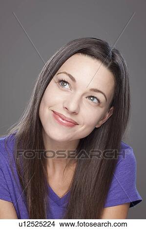 Picture - Studio shot of smiling young woman. Fotosearch
