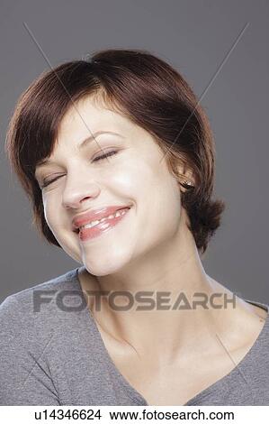 Picture - Studio shot of smiling young woman. Fotosearch