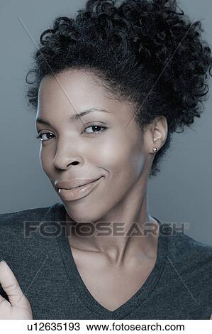 Studio shot of smiling young woman View Large Photo Image Stock Image - Studio shot of smiling young woman. Fotosearch